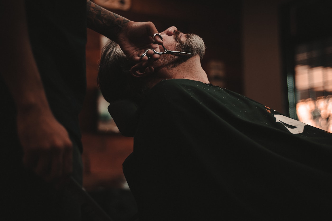 Barber detailing a beard with scissors